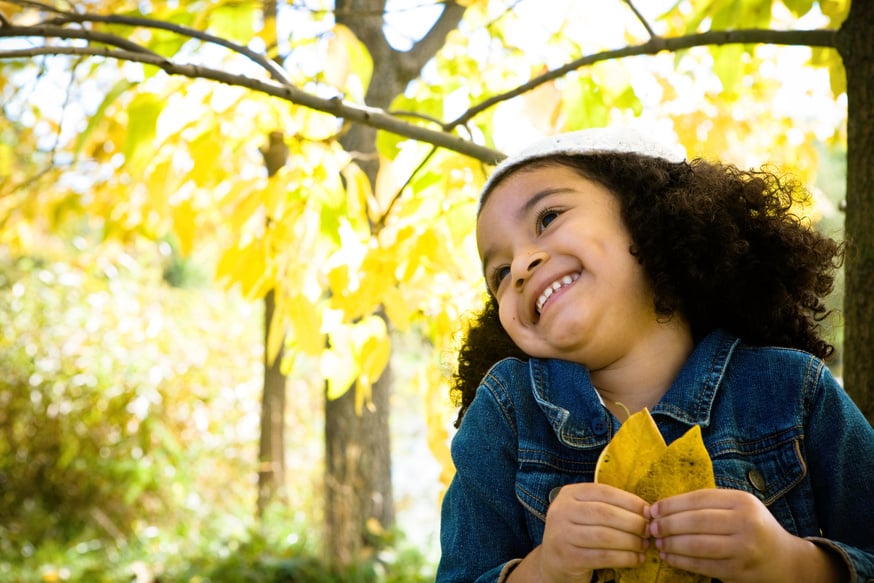 Happy Child Holding Leaves